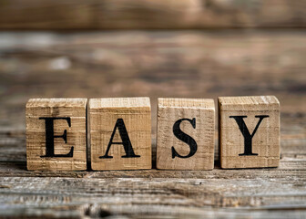 Wooden Blocks Spelling 'EASY' on Rustic Table with Blurred Background