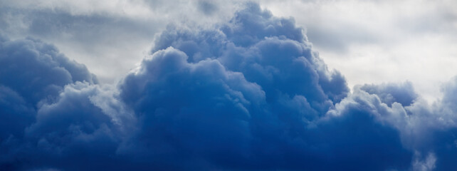 Dark blue cloud in the sky close-up, cloud as a storm warning, approaching storm, change of weather...