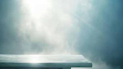 Mystical morning light rays piercing through fog onto a solitary white table.