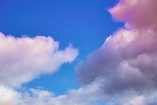 Cumulus clouds in unusual light in the sky, fantastic sky landscapes, unusual color of clouds in the sky, mystical clouds