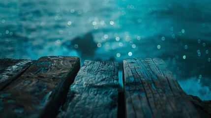 Fototapeten An evocative image of a weathered wooden pier with a mystical bokeh light effect over the ocean. © tashechka