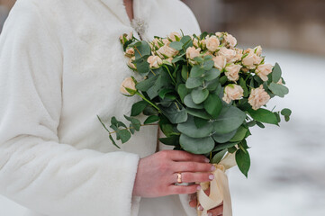 A beautiful wedding bouquet in the hands of the bride. Bouquet with white flowers in the hands of the bride