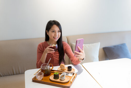 Woman take selfie with smart phone in cafe