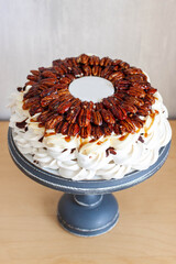 Delicious Pavlova cake with pecans, chocolate sauce, maple syrup and fondant plate for text
