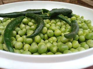 Grains or seed of Pisum sativum with Lycopersicon esculentum or Capsicum annuum L Green chilli  or pea grains or seeds with Green chilli or garden pea seeds or grains with Green chilli