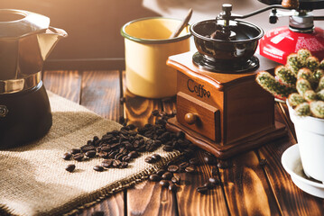 Cup Of Coffee, beans roating and Ingredients for making coffee and accessories on the table wooden background. Coffee making concept - obrazy, fototapety, plakaty