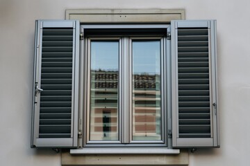 Fototapeta premium aluminum window with builtin shutters being closed 