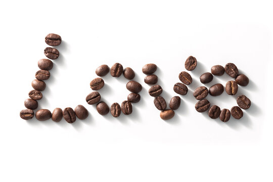 Love sign with coffee beans arranged over white background.