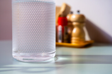 Glass of water with a bottle on table