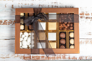 Packaged chocolate box. Pastry product. Gift chocolate box prepared with various chocolates on a white background. Top view