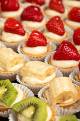 Tartlet types. Pastry product. Tartlets with kiwi, banana and strawberry on a white background. local name