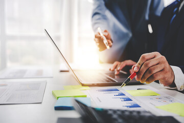 Colleagues discuss business charts and analytical prices using calculators and laptops to calculate finance, taxes, accounting, statistics, teamwork concept. Calculate personal taxes for clients