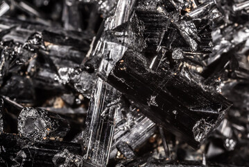 Tourmaline black crystals. Gems. Mineral crystals in the natural environment. Texture of precious and semiprecious stones. Seamless background with copy space colored shiny surface of precious stones.