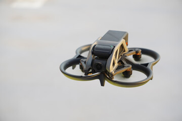 power drone fpv style flying in the road, compact size and protection propellers