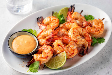 Grilled shrimps. Shrimps skewers, lime and fresh herbs