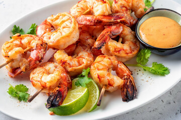 Grilled shrimps. Shrimps skewers, lime and fresh herbs