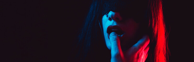 sexy submissive woman girl with a blindfold sucks the dominant man finger with her lips. BDSM sex with domination and submission. Wide banner - obrazy, fototapety, plakaty