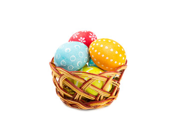 Easter basket filled with colorful eggs isolated on white background. Easter celebration concept. Colorful easter handmade decorated Easter eggs.