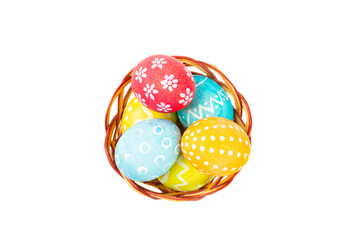 Easter basket filled with colorful eggs isolated on white background. Easter celebration concept. Colorful easter handmade decorated Easter eggs.