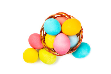 Easter basket filled with colorful eggs isolated on white background. Easter celebration concept. Colorful easter handmade decorated Easter eggs.