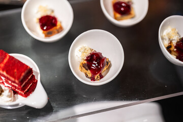 Small pieces of various tasty cake, there are placed on the international buffet meal. Sweet dessert food object photo, Close-up and selective focus.