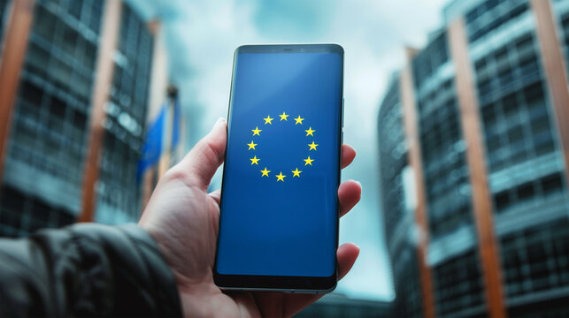 Stars from European Union Flag on Smartphone in Man's Hand in Front of European Parliament Buildings, EU Political Integration and Unity.