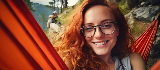 Cheerful Woman Relaxing on Red Hammock in Forest Setting
