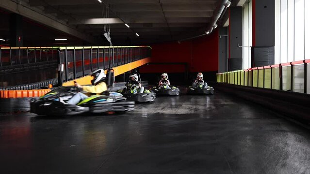group of racers start the kart race on the circuit driving in the first turn