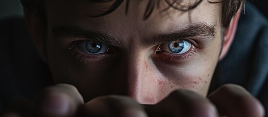 Portrait of a Man with Intense Blue Eyes Showing Signs of Stress and Anxiety - obrazy, fototapety, plakaty
