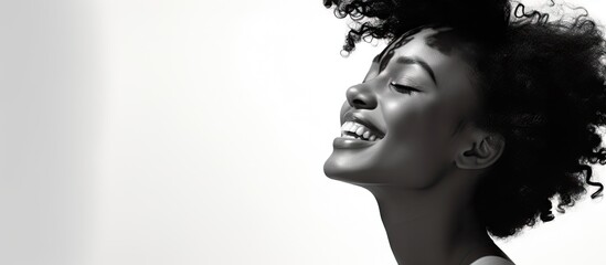 Young African American woman with curly hair joyfully smiling and gazing upwards