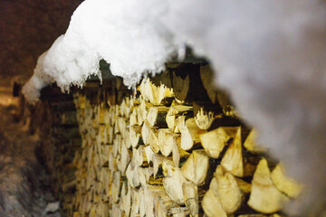  Firewood prepared for the winter. Lying in the snow. Winter Night