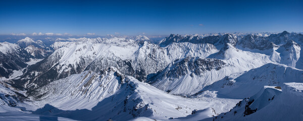Winter mountain panorama from mountain peak of Namloser Wetterspitze in Tyrol, Austria, sunny blue sky day. - 745923664