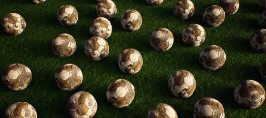 A collection of worn old footballs on artificial grass. Lit by sunlight. - 745931091
