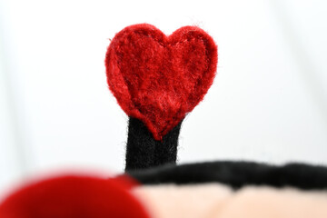 red felt heart close-up on white background
