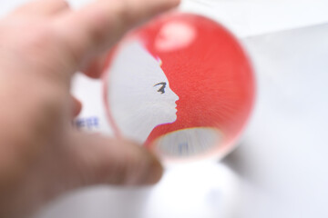 marianne symbol in front of red flag seen in a crystal ball