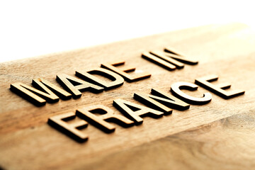 Made in France with wooden letters on textured background