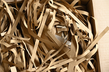 cut pieces of kraft paper for the protection of fragile objects in a package
