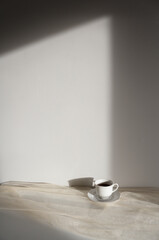 Minimalist morning background with coffee, neutral and beige aesthetic, sunlight, copy space