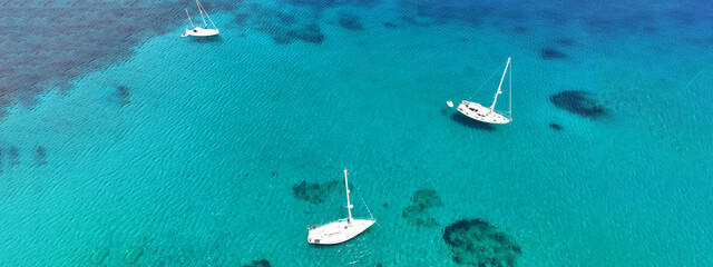 Aerial drone ultra wide photo of sail boat anchored in tropical exotic turquoise calm waters...
