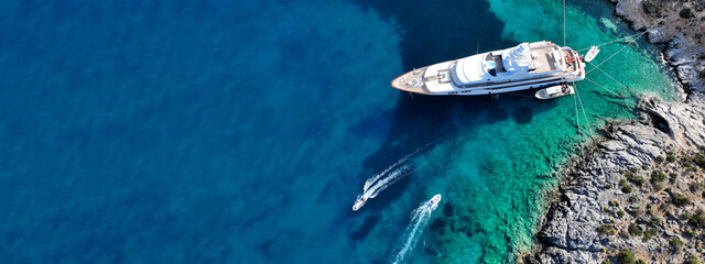 Aerial drone ultra wide top down photo with copy space of luxury yacht anchored in tropical exotic...