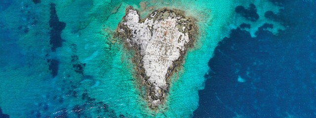 Aerial drone ultra wide photo of secluded heart shaped island with turquoise sea in Caribbean exotic destination