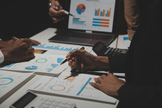 Financial analysts analyze business financial reports on a digital tablet planning investment project during a discussion at a meeting of corporate showing the results of their successful teamwork.