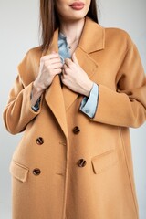 Elegant woman in stylish warm wool coat isolated on white background