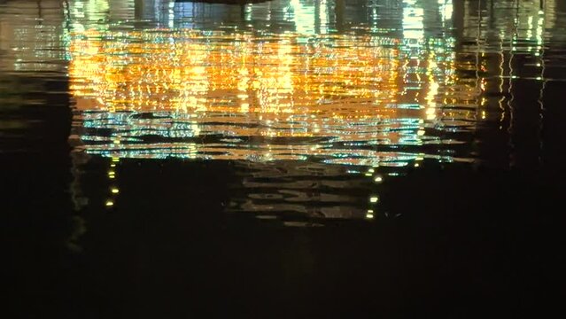 Light reflection on water surface at night