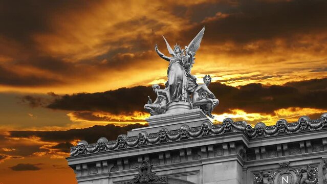 Golden statue of Liberty on the roof of the Opera Garnier (Garnier Palace)  against the background of the sunset. Sculpted by Charles Gumery in 1869. Paris, France. 4K, time lapse  