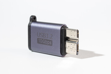 Isolated dark gray USB With HDD adapter on a white background.