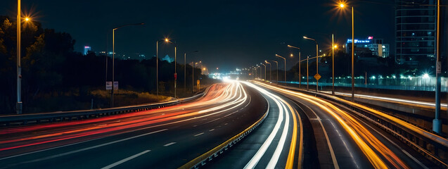 Fototapeta na wymiar Nighttime highway with streaks of car lights, creating a dynamic urban motion scene.