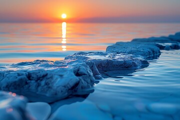 The glow of the sunset over calm waters with a path of stones leading towards the horizon epitomizes serenity - Powered by Adobe