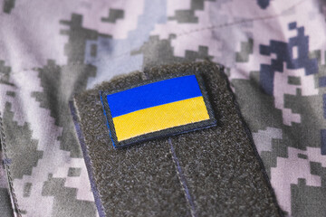 Close up khaki camouflage amunition. Armed Forces of Ukraine. Ukrainian army. Ukrainian flag on military uniform.