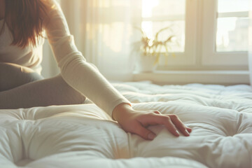 Obraz na płótnie Canvas Woman touching white soft mattress indoors, closeup